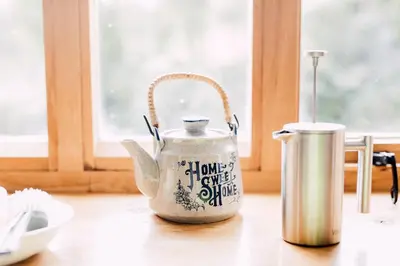a tea pot sitting on a table next to a tin at The Barn at Ty Beic in Bala