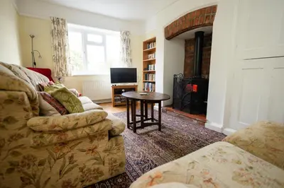 a living room with a couch and a table at Oak House in Mid Wales with Log Burner By Seren Short Stays in Machynlleth