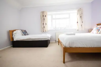 a bedroom with two beds and a window at Oak House in Mid Wales with Log Burner By Seren Short Stays in Machynlleth