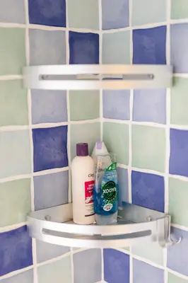 a shelf in a bathroom with cleaning products on it at Oak House in Mid Wales with Log Burner By Seren Short Stays in Machynlleth