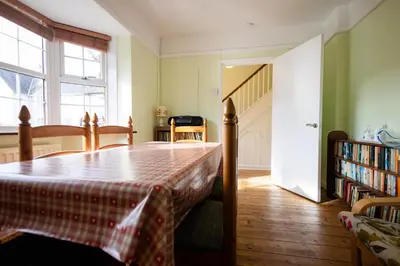 a bedroom with a bed and a book shelf with books at Oak House in Mid Wales with Log Burner By Seren Short Stays in Machynlleth