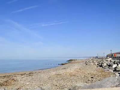 a beach with rocks and the ocean on a clear day at Penrhiw in Llangeitho