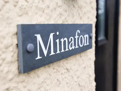 a sign on the side of a building at Minafon in Llangollen