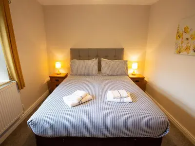 a bedroom with a bed with two towels on it at Hafan in Llangollen