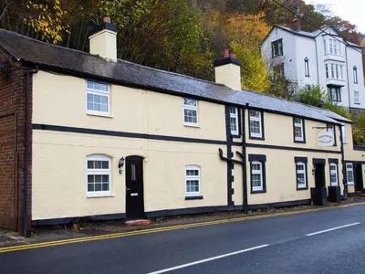 a white building on the side of a street at Catref in Llangollen