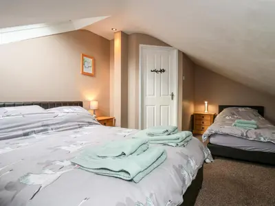 a bedroom with a bed with towels on it at Fisher Granary in Lampeter