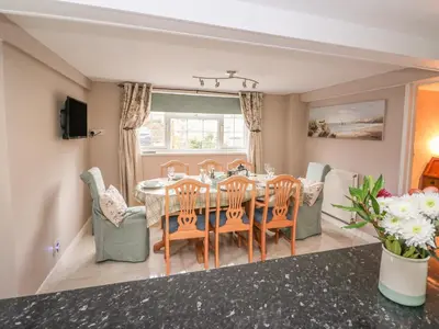 a dining room with a table and chairs at Fisher Granary in Lampeter