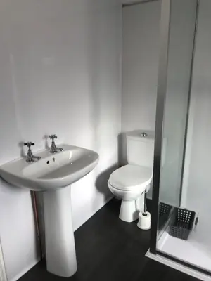 a bathroom with a white sink and a toilet at Heulwen in Barmouth