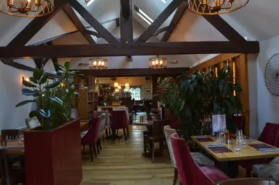 a dining room with wooden tables and chairs at The Nags Head in Montgomery