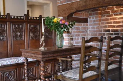 a table with a vase of flowers on it at The Nags Head in Montgomery
