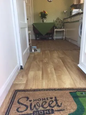 an entrance to a kitchen with a rug on the floor at 11 Callow Crescent in Minsterley
