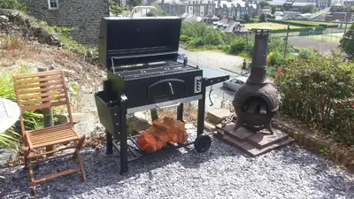 a grill and a wood fired oven on a patio at Apartment Chic in Barmouth