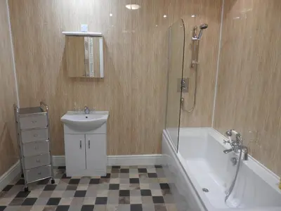 a bathroom with a shower and a sink and a bath tub at Hawen - Barmouth in Barmouth