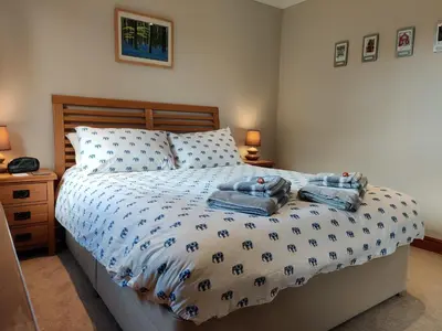 a bedroom with a bed with two towels on it at Nant Gloyw Oswestry in Oswestry