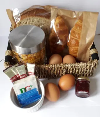 a basket filled with bread and eggs on a table at Lucea Cottage in Craven Arms