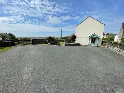 a white building on the side of a road at Tyn Y Buarth in Dyffryn