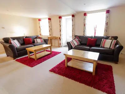 a living room with two couches and a coffee table at Tyn Y Buarth in Dyffryn