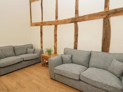 a living room with two couches and a table at The Stables in Knighton