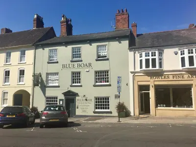 a blue book building on the corner of a street at Beautiful stylish 2 bed apartment with free parking in Ludlow