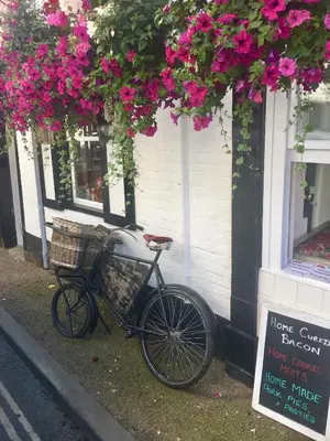 a bike parked in front of a store with flowers at Beautiful stylish 2 bed apartment with free parking in Ludlow