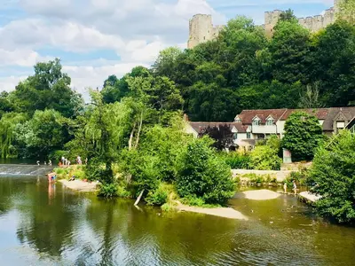 a body of water with a castle in the background at Beautiful stylish 2 bed apartment with free parking in Ludlow