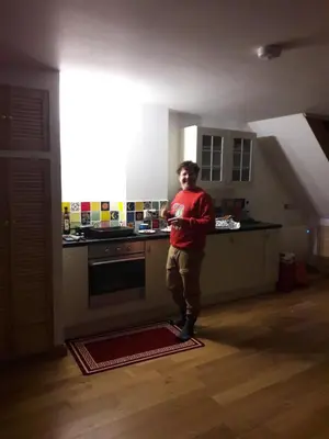 a man standing in a kitchen in a room at The Barn Annexe, Cefn-Yr-Allt in Crickadarn