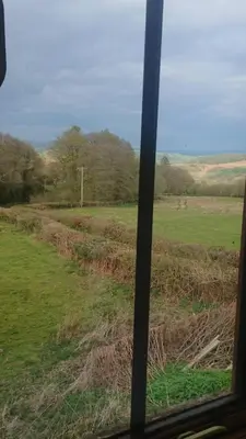 a view of a field from a train window at The Barn Annexe, Cefn-Yr-Allt in Crickadarn