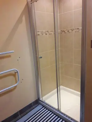 a shower with a glass door in a bathroom at The Barn Annexe, Cefn-Yr-Allt in Crickadarn