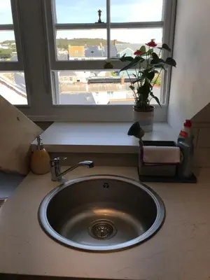 a sink in a kitchen with a window at Apartment 4, 1 Laura Place in Aberystwyth