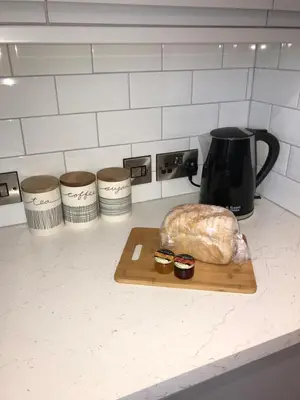 a loaf of bread on a cutting board on a kitchen counter at Apartment 4, 1 Laura Place in Aberystwyth