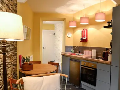 a kitchen with a table and a dining room at Tŷ Ar Y Tro in Tanygrisiau