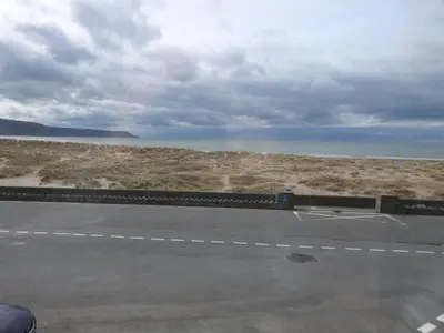 an empty road with a view of the ocean at Môr Wyn Guest House in Barmouth
