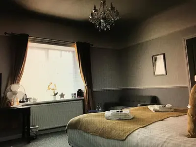 a bedroom with a large bed and a window at The Black Lion Royal Hotel in Lampeter