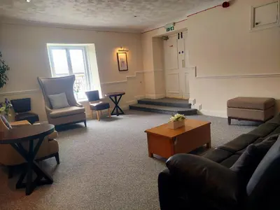 a living room with a couch and chairs at The Black Lion Royal Hotel in Lampeter