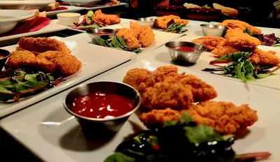 a table topped with plates of food with dipping sauce at The Black Lion Royal Hotel in Lampeter