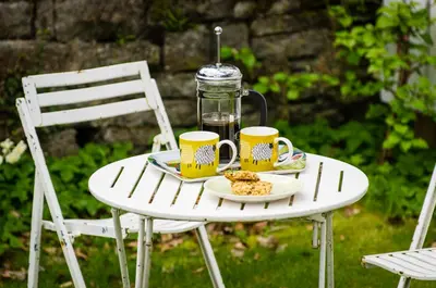 a table with two mugs and a jar on it at Station Cottage in Bucknell