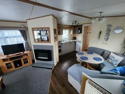 a living room with a couch and a table at 92 Barmouth Bay Holiday Park in Llanddwywe