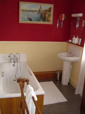 a bathroom with a white tub and a sink at Ardwyn House in Llanwrtyd Wells