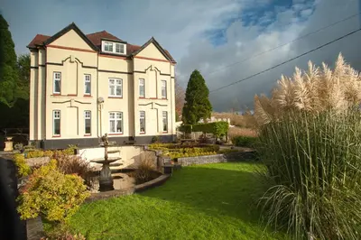 a large house with a garden in front of it at Ardwyn House in Llanwrtyd Wells