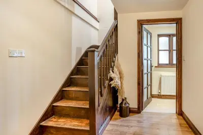 a staircase in a home with a wooden stair case at 2 Bed in Trallong oc-bow106 in Sennybridge