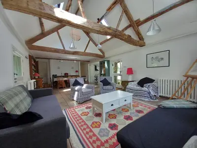 a living room with couches and a coffee table at Gesail Barn and Farmhouse in Machynlleth