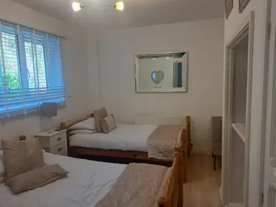 a bedroom with two beds and a mirror on the wall at Snowdonia Mawddach escape in Dolgellau