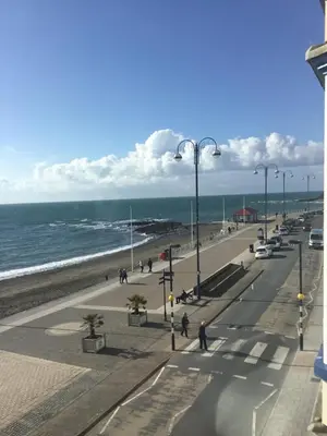 a view of a beach with people and the ocean at Helmsman Guesthouse in Aberystwyth