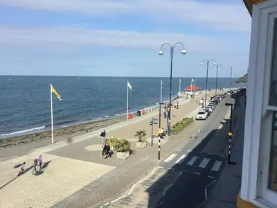 a view of the beach from a balcony of a building at Helmsman Guesthouse in Aberystwyth