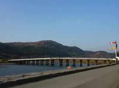a bridge over the water next to a road at Hawddamor in Dolgellau