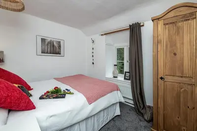 a bedroom with a bed with a tray of fruit on it at Hawddamor in Dolgellau
