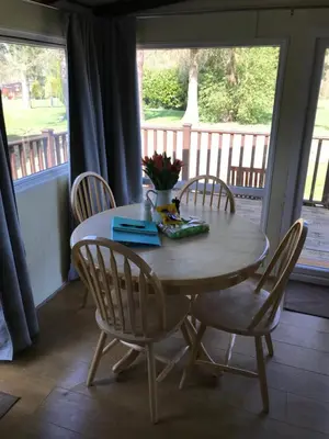 a table and chairs in a room with a porch at Sherdale lodge in Builth Wells