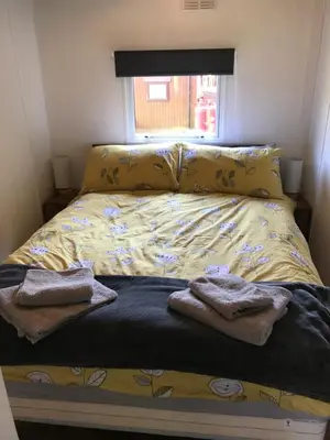 a bedroom with a bed with towels on it at Sherdale lodge in Builth Wells