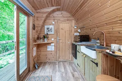 an interior view of a kitchen in a tiny house at Nyth Y Goedwig in Dolgellau