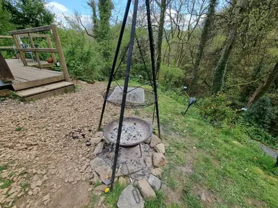 a swing in a yard with rocks and trees at Nyth Y Goedwig in Dolgellau